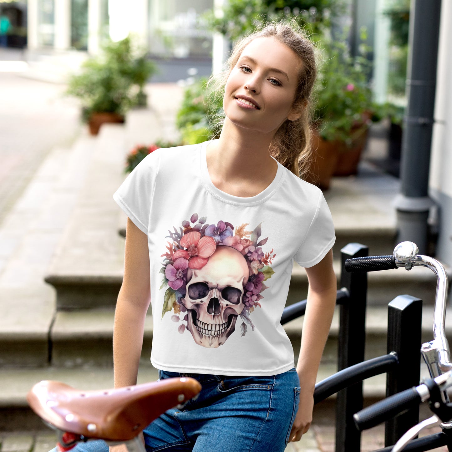 "Elegant Eerie Blooms" Women's Cropped Tee: Embrace Halloween in Style with a Skull Surrounded by Pink Flowers Design